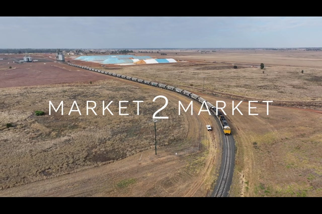 Aerial footage of freight train traveling along track at the CQ Inland Port Facility, Emerald