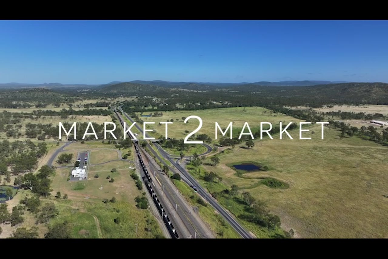 Aerial footage over highway and train line in a regional area of Central Queensland